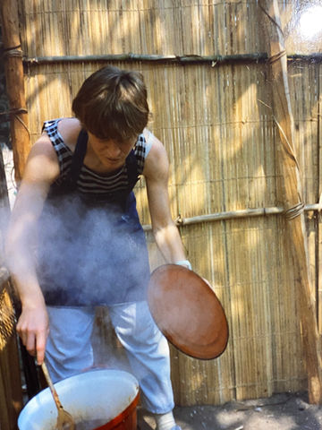 Anita outside in Congo cooking over open fire