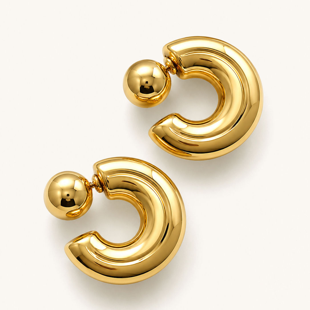 Close-up of Valentina Gold Statement Hoop Earrings with polished gold finish and sculptural design