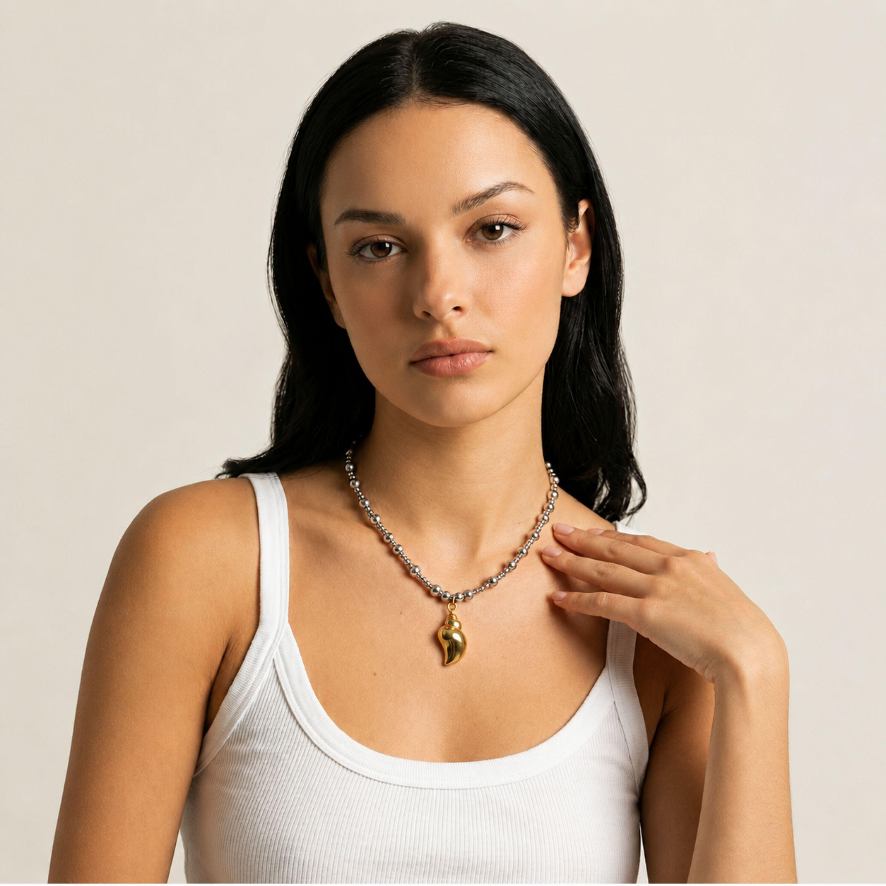 Mixed metal shell necklace styled in high-end fashion portrait