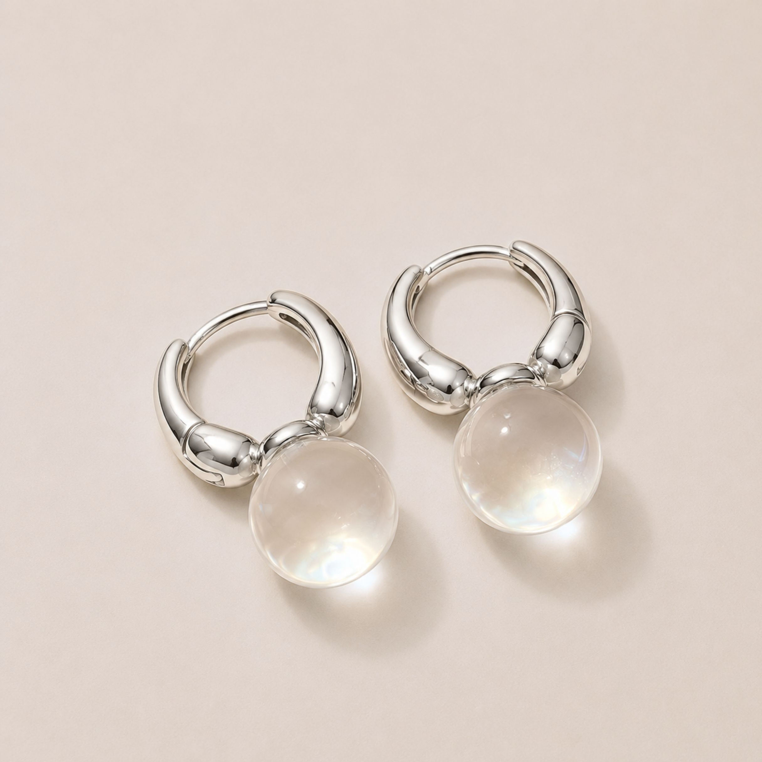 Minimalist silver huggy hoop earrings with clear resin sphere drops, Luna Crystal Sphere Drop Huggy Earrings.