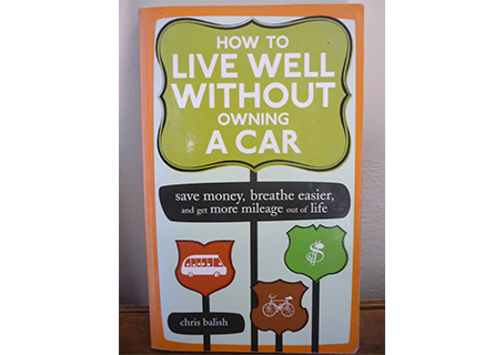 Book cover How to Live Well Without Owning a Car, with bus, bike, and dollar sign icons on orange and green signs.