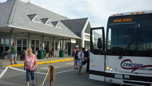 People boarding a bus at a bus station