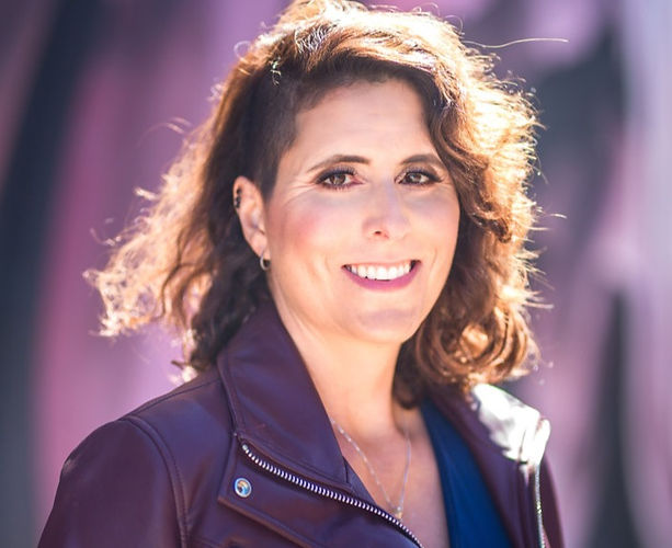 A beautiful woman in a leather jacket.
