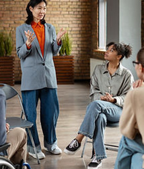 Asian businesswoman leading diverse team meeting, discussing project strategy and sharing