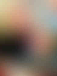 Toddler creating unique patterns with paint on a mirror.