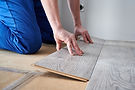 male-worker-hands-laying-laminate-flooring-apartment.jpg