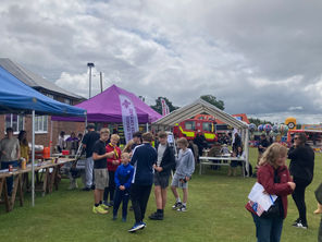 Photos from the Holmes Chapel Village Fair 2025 featuring various stalls on a field.