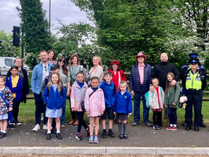 A group of residents walk to school to highlight the importance of safe walking routes