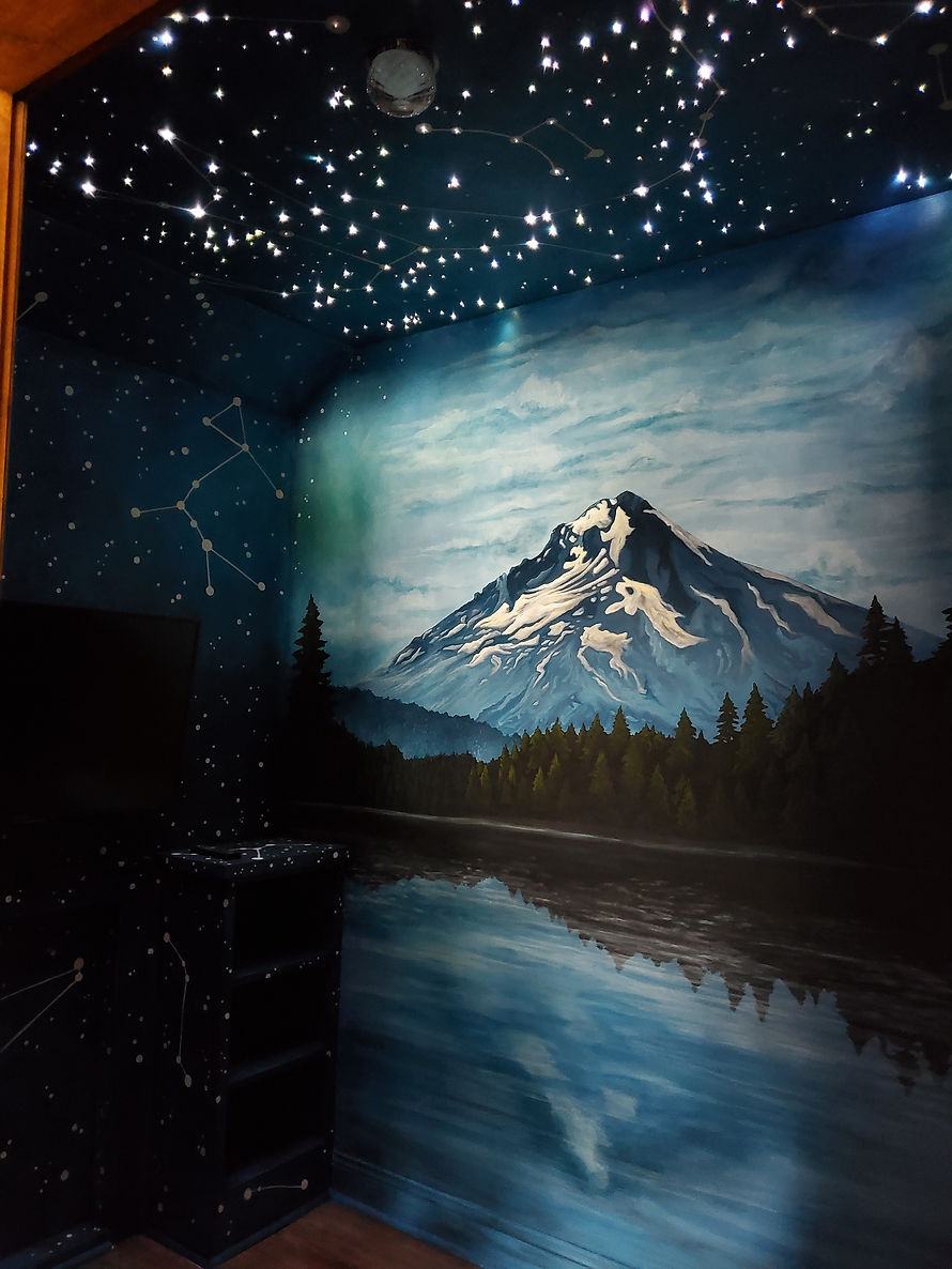 A custom handpainted mural of forest, trees, mountains and water, for a private residence.