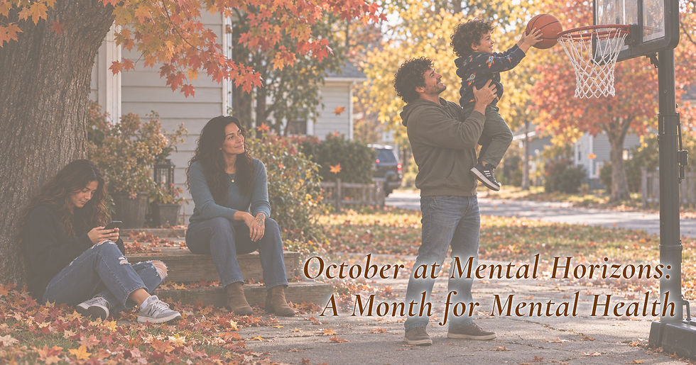 A family shares an autumn afternoon outside as a father lifts his young son toward a basketball hoop, while a mother watches and a teen uses her phone.