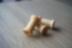 縮圖：Three wooden string reels placed together.