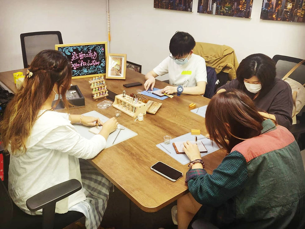 Inside a string art workshop: Instructor Kimmy Wong from String Art Laboratory guiding three participants, immersed in the creative process of crafting intricate string art designs.
