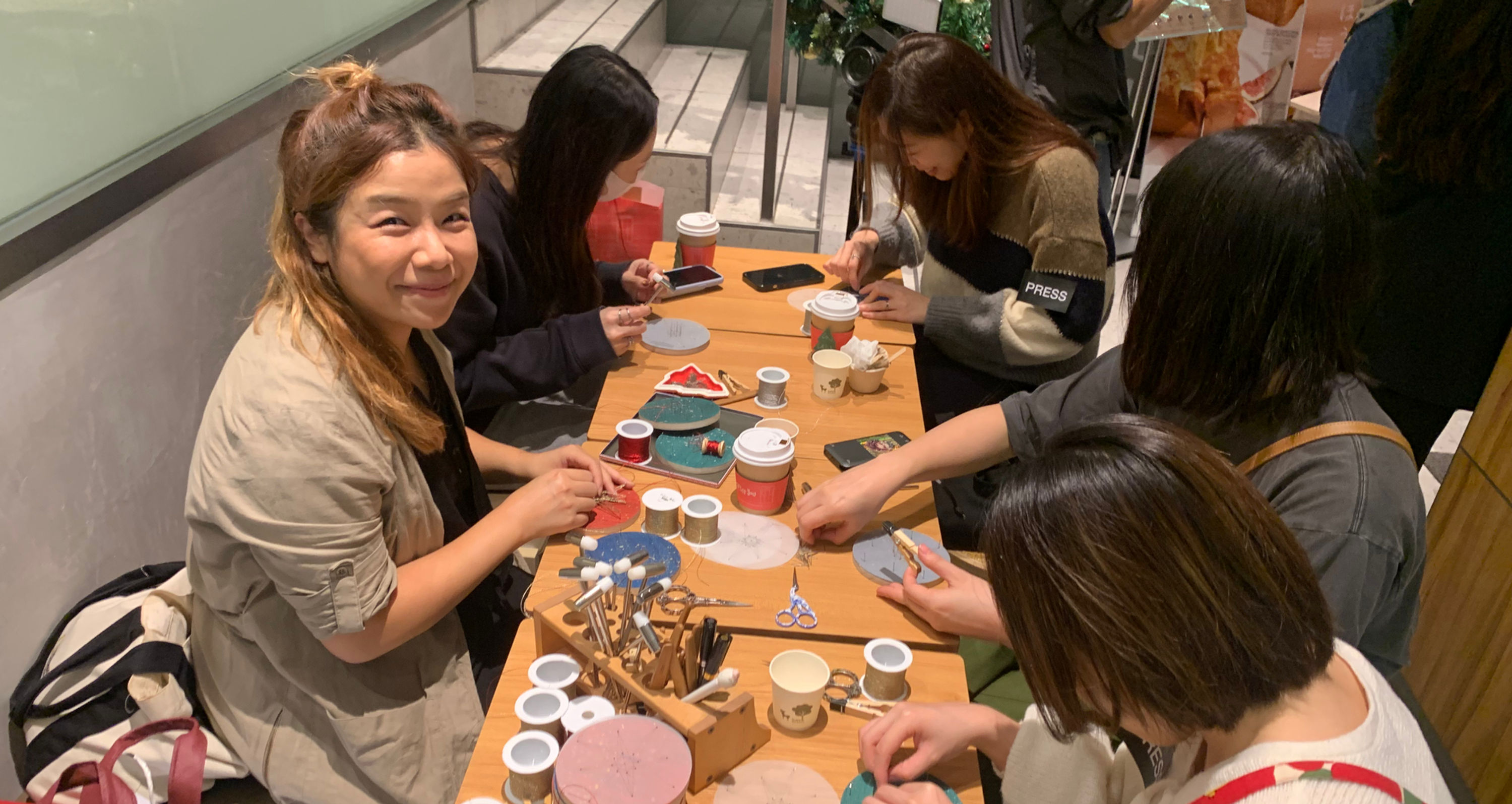 String art workshop in progress, participants focused on crafting.