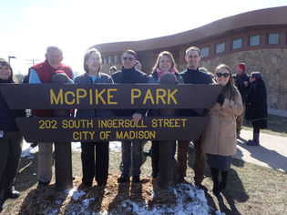 MPF board members wrap around the new McPike Park sign in Madison, WI