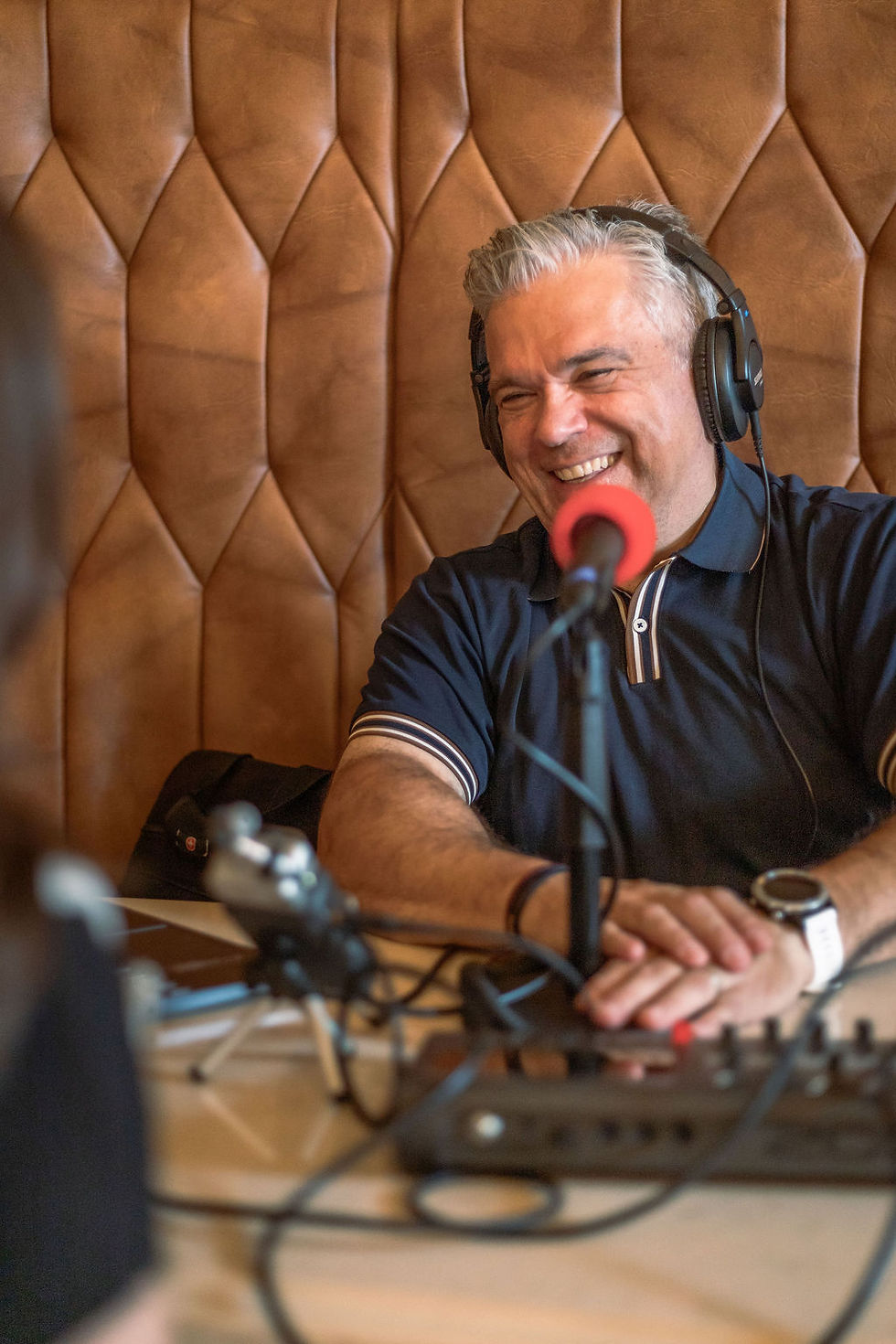 Man doing a podcast with a client - Between the Wines Media