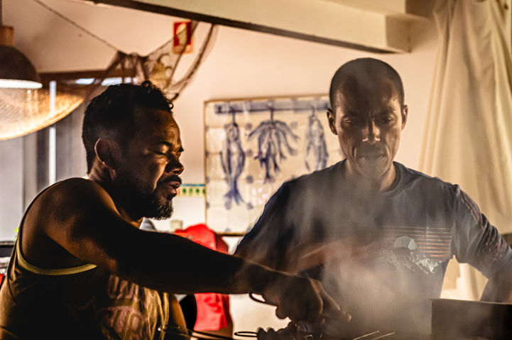 Two good friends cooking meal on the grill