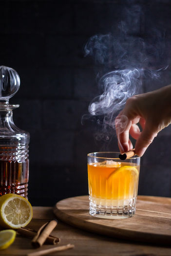 Whiskey sour with smoking cinnamon stick