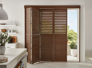 This kitchen features bifold hardwood shutters to cover their sliding glass door while still allowing natural light to filter in.