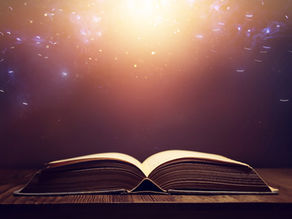 An open book resting on a wooden surface, softly illuminated, symbolizing time, space, reflection, and the exploration of new possibilities.