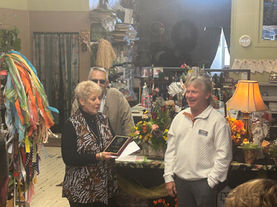 Christie Rasure being presented the award for her business Designs Unlimited