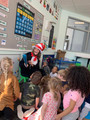 New Creations teacher dressed as cat in the hat reading to toddlers