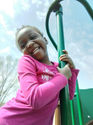 Child playing on outdoor playground in Burnsville