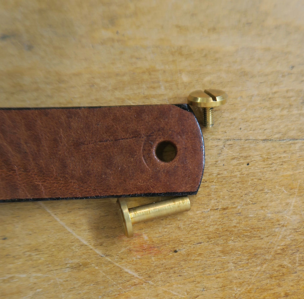 Thumbnail: Detail of brass bolt, open with end of leather loop showing