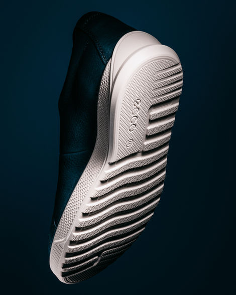 Product photograph of blue Ecco sneakers on a dark blue background.