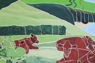 Devon red cattle resting in a meadow overlooking the sea