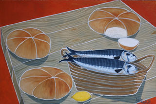 Two mackerel on a basket surrounded by three bread loaves (one cut open) on a table top and a lemon