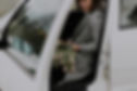 Woman getting out of car with flowers