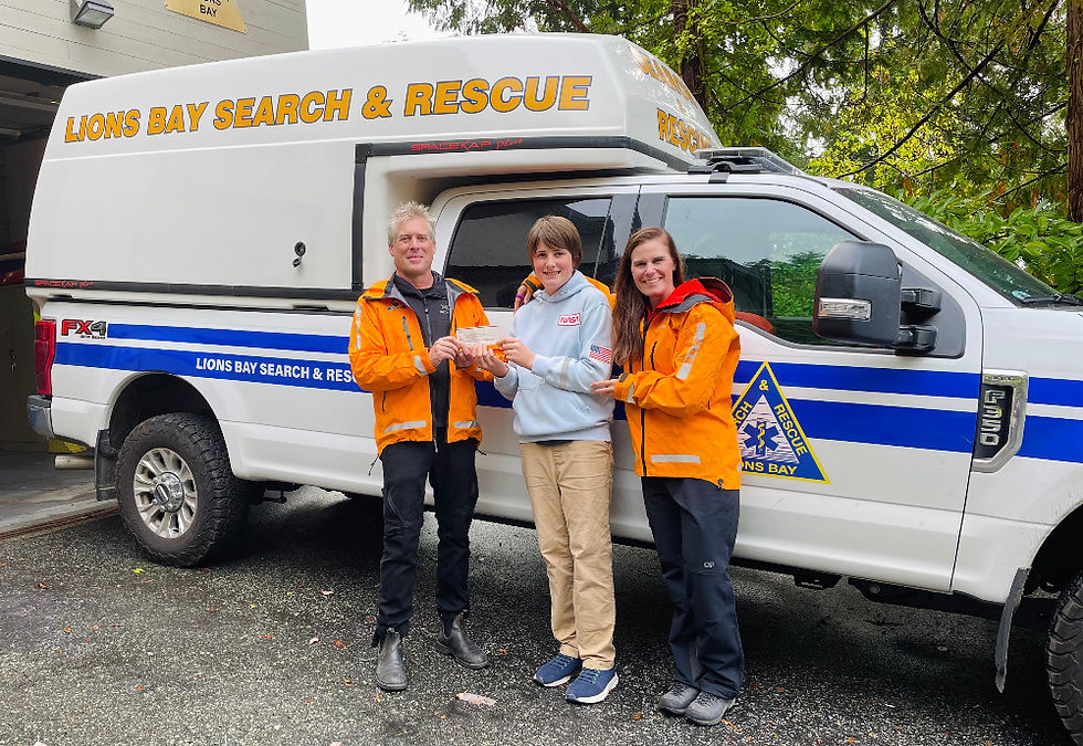 Brent Calkin and Maria Maria Masiar of LBSAR accept a donation from Archie (centre).