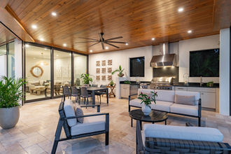 Renovated outdoor kitchen and covered patio with wood ceiling, luxury Florida home