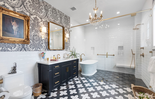 opulent bathroom with black and white floor tile and chandelier