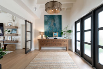 Modern, coastal entryway renovation with wood console and glass doors, Treasure Coast