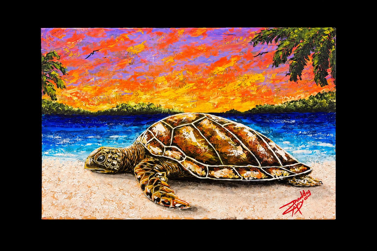 Sea turtle on a beach beneath a vibrant sunset