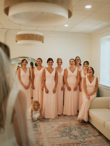 Bridal party smiling at a bride reveal in the bridal suite in Paoli, PA