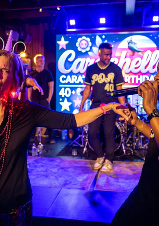 PDA band singer out in the crowd with a lady dancing