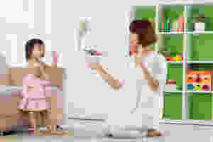 Daughter and Mother with hands up together.