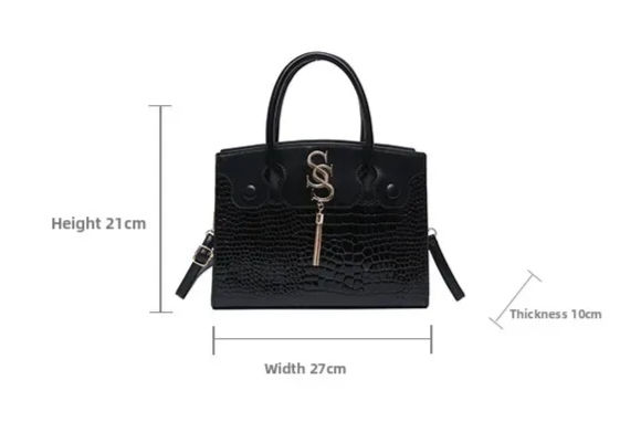 Thumbnail: Black crocodile-embossed handbag, 21cm height, width 27cm with gold tassel.