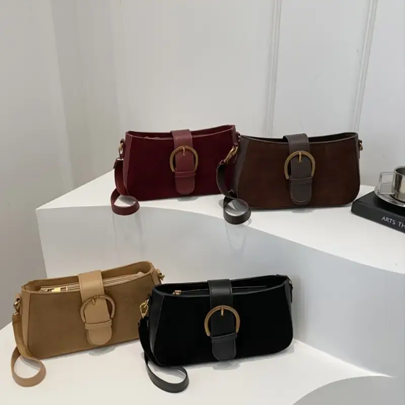 Thumbnail: Four suede shoulder bags in red, brown, tan, and black with buckles.