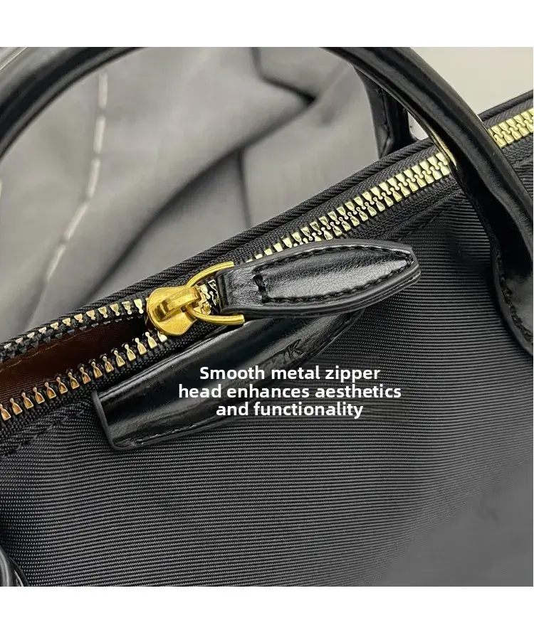 Thumbnail: Smooth metal zipper head enhances aesthetics and functionality on black bag.