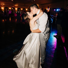 Bride and groom sharing a kiss on dance floor