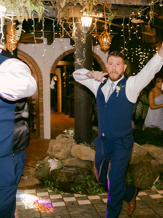 Guests dance joyfully at wedding reception