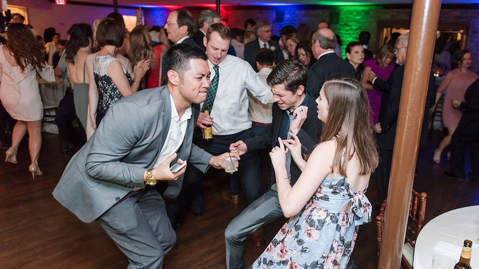 Wedding guests laughing and dancing at a Houston reception with AMP Events and Lighting