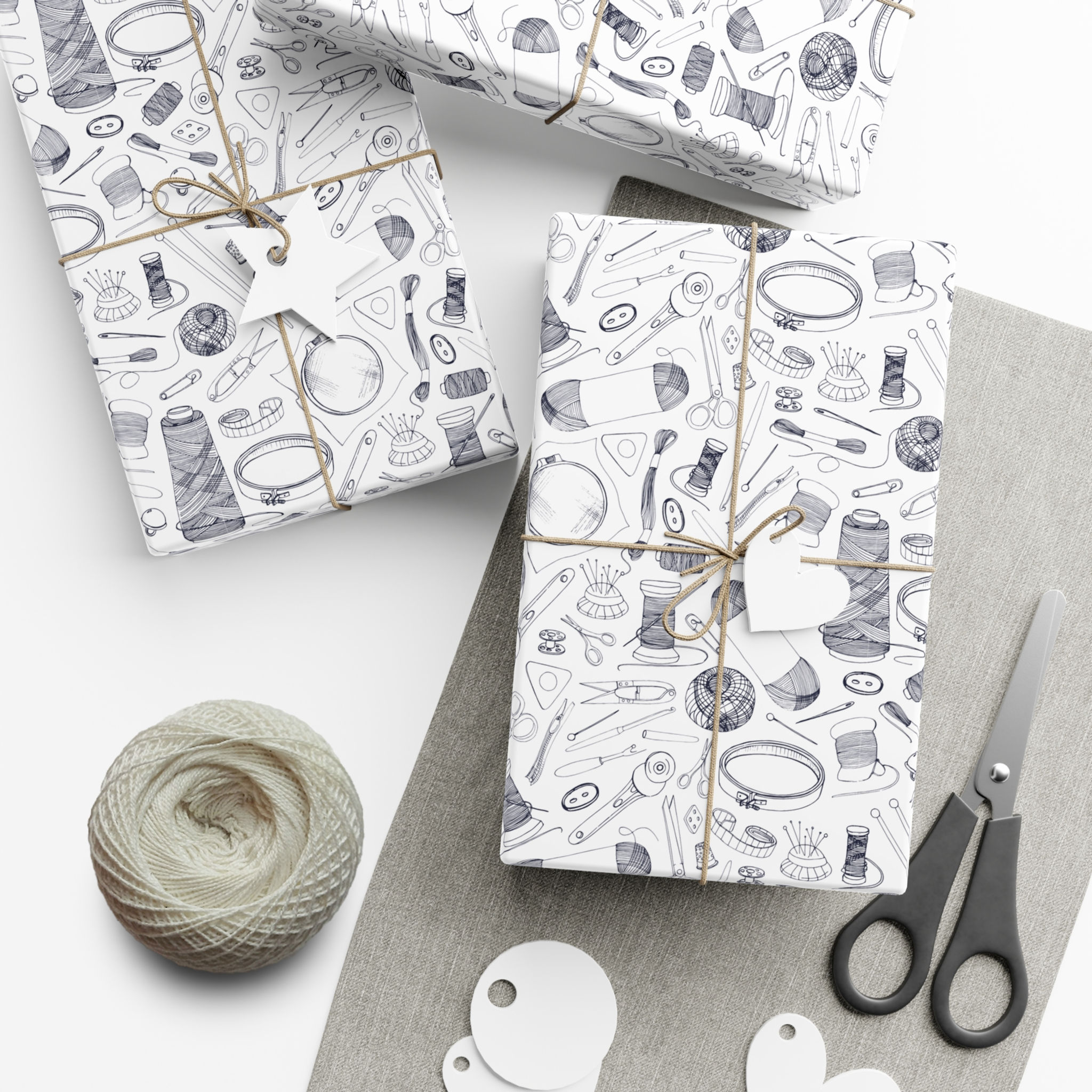 Wrapped gifts with hand-drawn sewing tools, scissors, string, and tags. Black and White Sewing Gift Wrap | Hand Drawn Thread, Scissors and Needles
