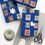 Thumbnail: Blue gift boxes with stamps, twine, scissors and tags for wrapping presents.