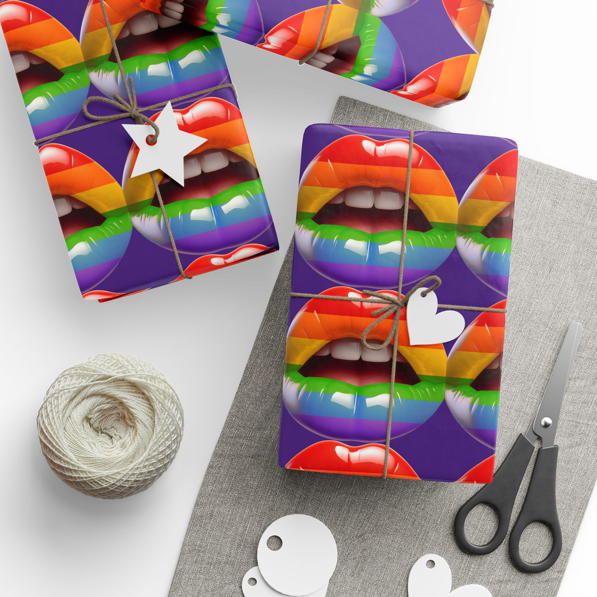 Wrapped gifts with rainbow lip-print wrapping paper and gift tags near scissors.