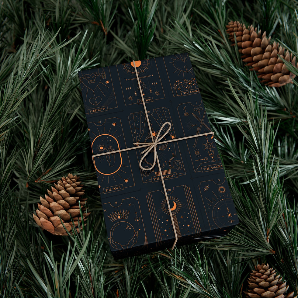 Thumbnail: Gift wrapped with black paper and gold design, tied with twine, pine needles.