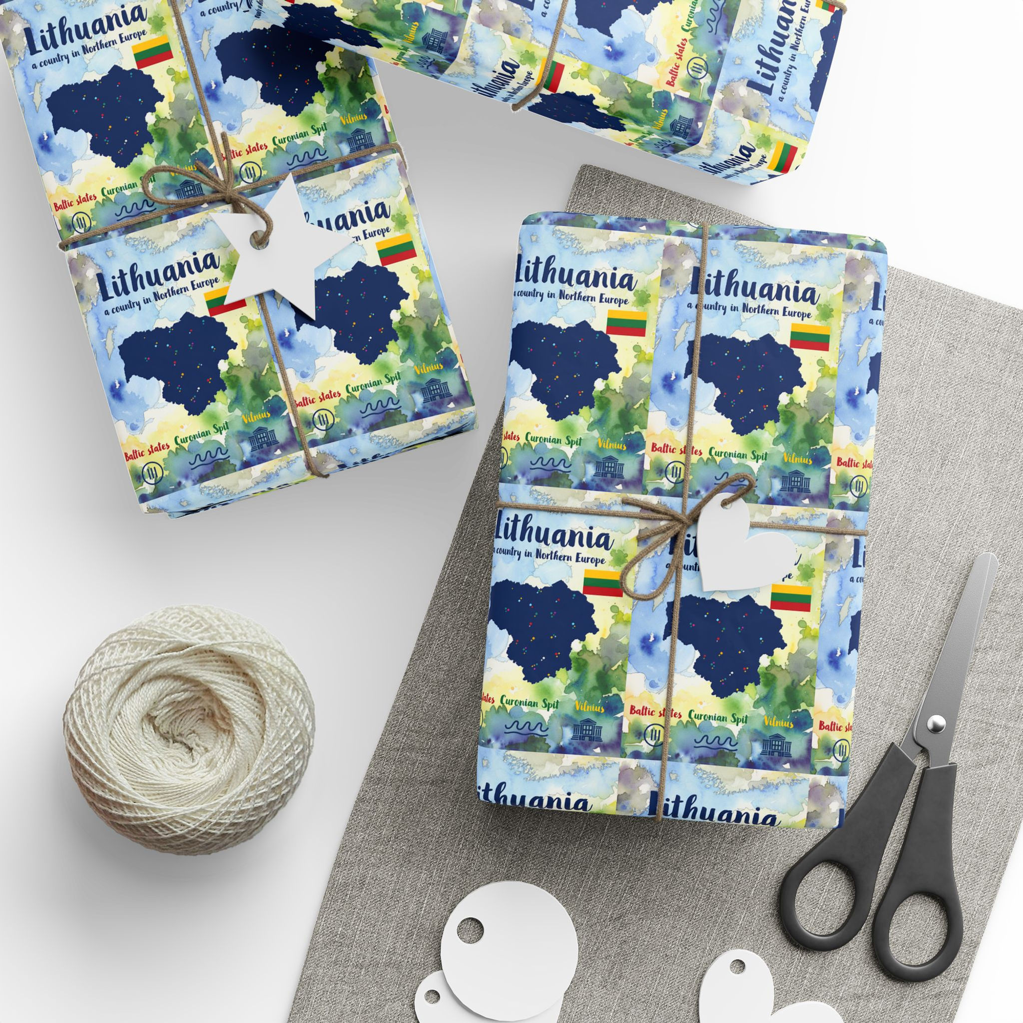 Gift boxes wrapped in Lithuania paper, map, 'Lithuania is in Europe' text, twine.
